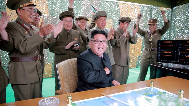 Kim Jong Un reacts during a test launch of ground-to-ground medium long-range ballistic rocket Hwasong-10