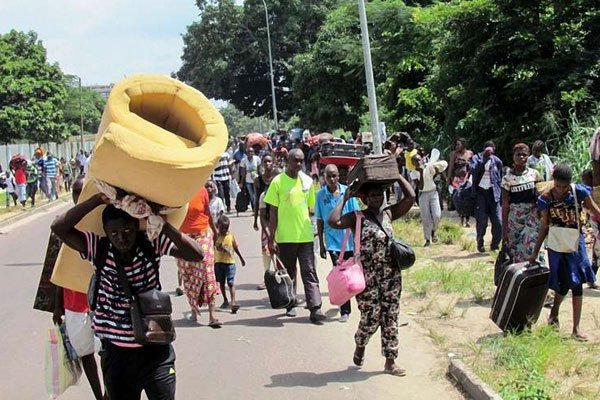Residents of the southern districts of Brazzaville flee clashes between Congolese security forces and unknown assailants on April 4, 2016.