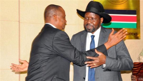 Kiir (right) embraces Deng after his swearing-in ceremony as first vice president