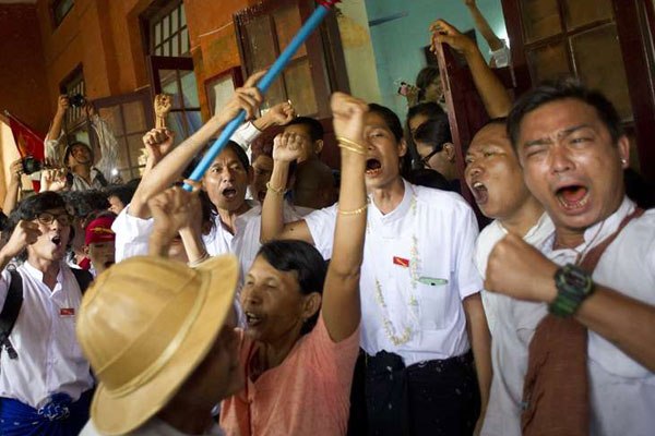 Newly-released political student protesters and family members shout and cheer after their release in Tharrawaddy town, Bago Region in Myanmar on April 8, 2016.