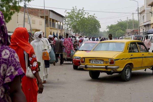 People walk at the cereal market in N'djamena on April 12, 2016, two days after Chad's presidential elections.