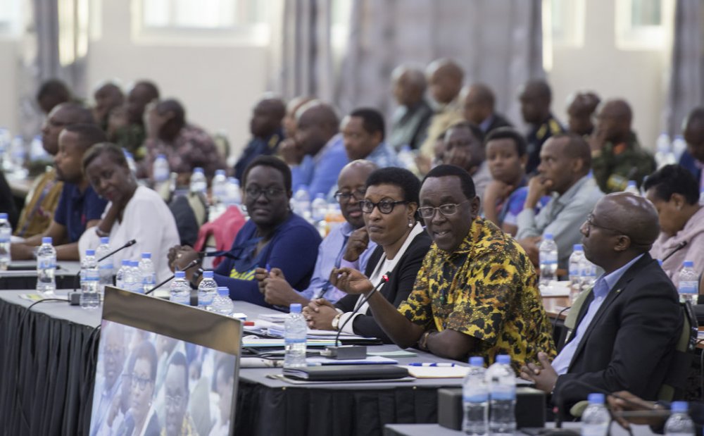Senate President Bernard Makuza speaks in the retreat as Prime Minister Dr. Edouard Ngirente (R) and other officials look on.