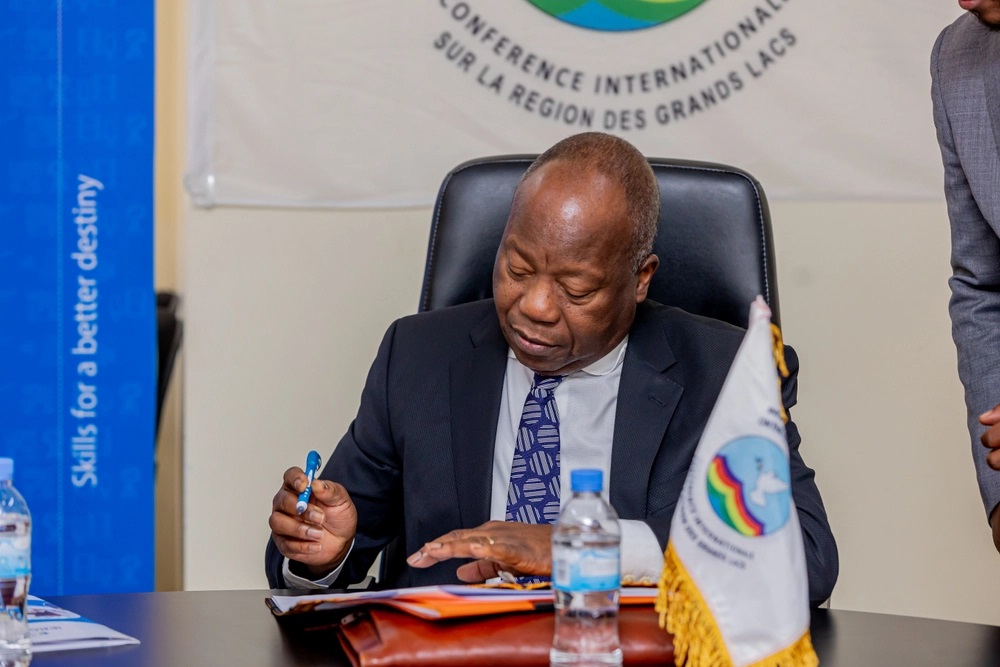 The Executive Secretary of the International Conference of the Great Lake Region ICGLR, Amb. Joao Samuel Caholo signing the document acknowledging receipt of equipment from GIZ.