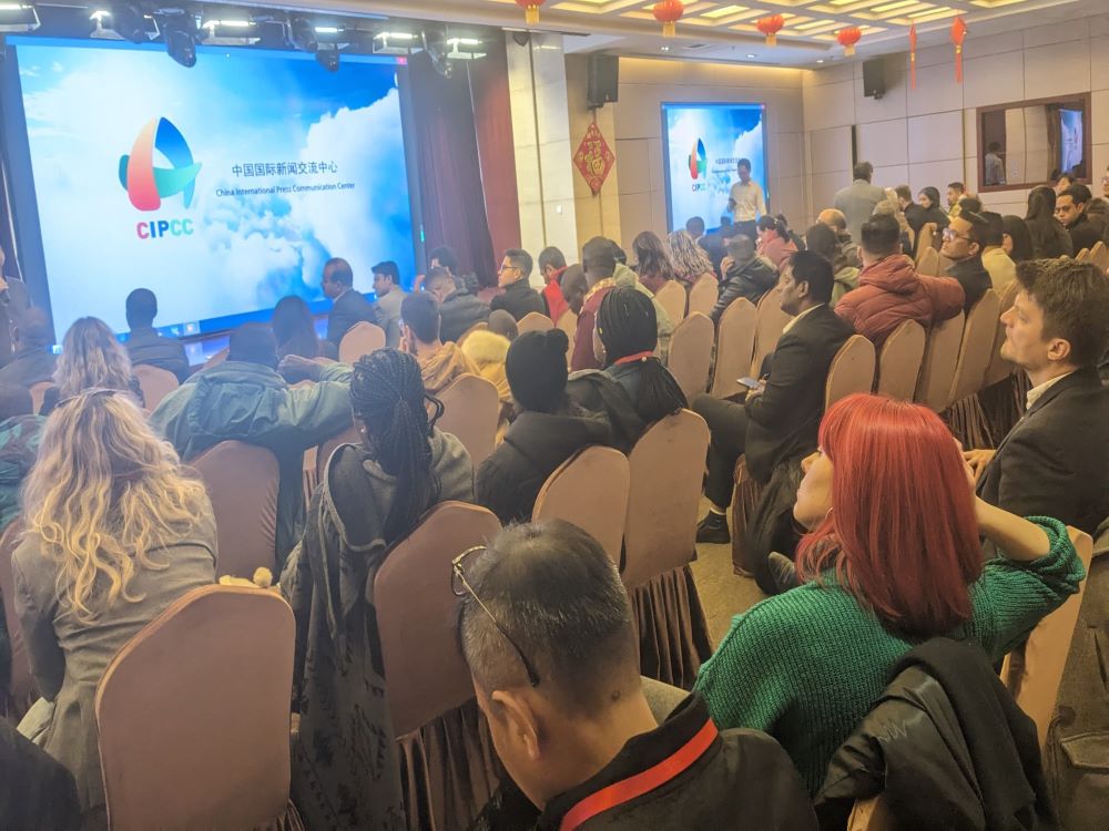 Journalists following presentations on the training program's calendar.  