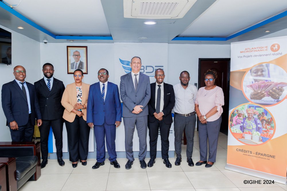 Employees of Atlantique Microfinance Plc and BDF after the two institutions signed a partnership agreement to promote financial services.
