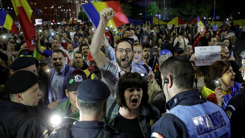Protesters shout slogans during a demonstration in front of government offices in Bucharest