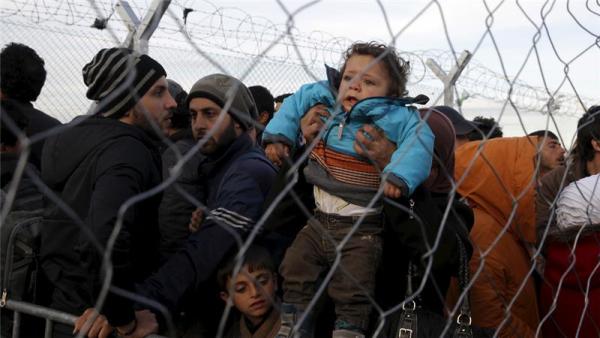 Refugees wait to cross the Greek-Macedonian border at a makeshift camp near Idomeni
