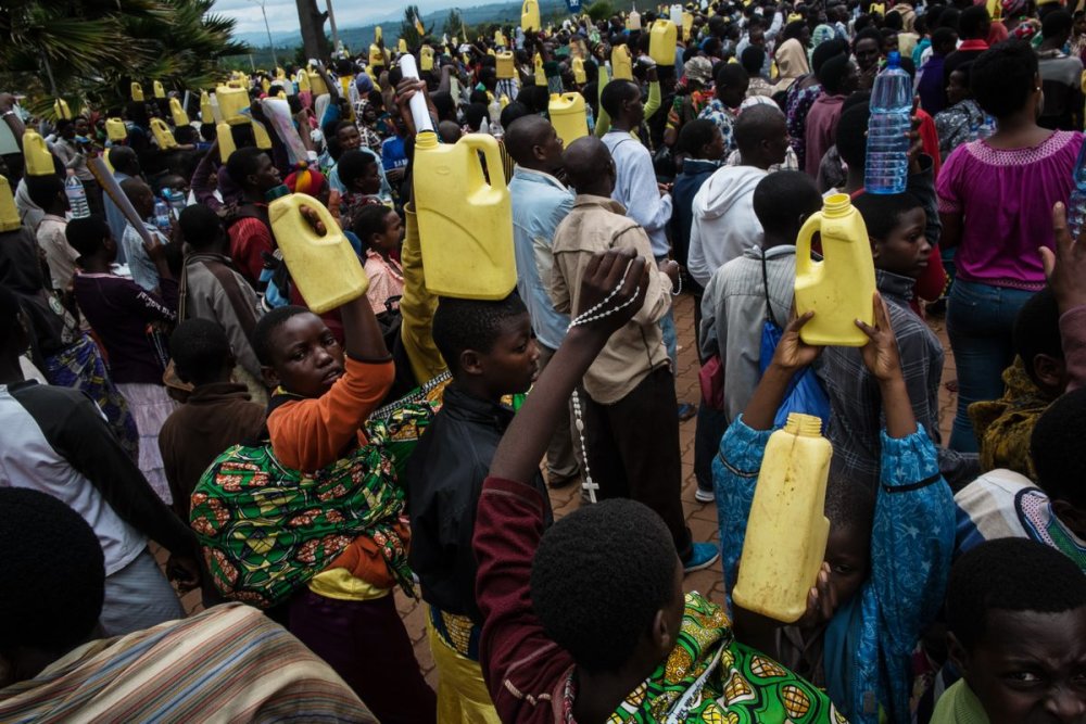 Pilgrims collect water in jerry cans, have it blessed by the priest, and take it with them when they depart.