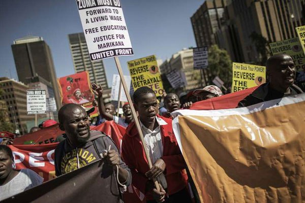 People shout slogans against South African President Jacob Zuma and the ruling African National Congress (ANC) party during a protest organised by the opposition political parties, Civil Society organizations and Religious group as the nation celebrates Freedom Day in Johannesburg on April 27, 2016.