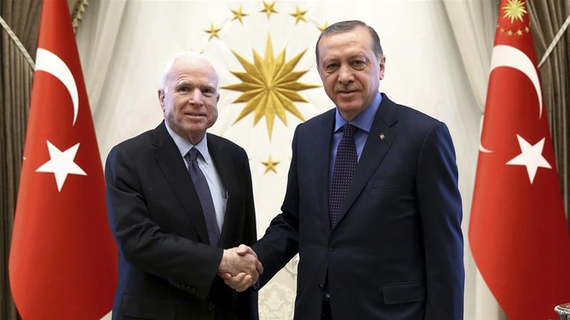 President Recep Tayyip Erdogan, right, and Senator John McCain shake hands prior to a meeting in February