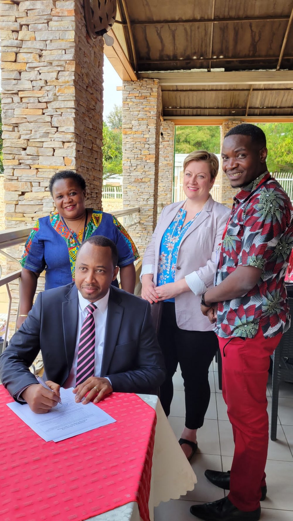 The President of RUPI, Munyaburanga signing a document admitting Rwanda into EAC and Commonwealth associations. 