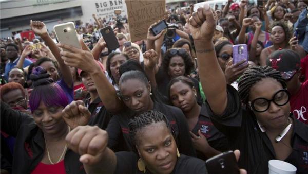 Demonstrators mourned the loss of Alton Sterling, chanting "black lives matter" and "hands up don't shoot"