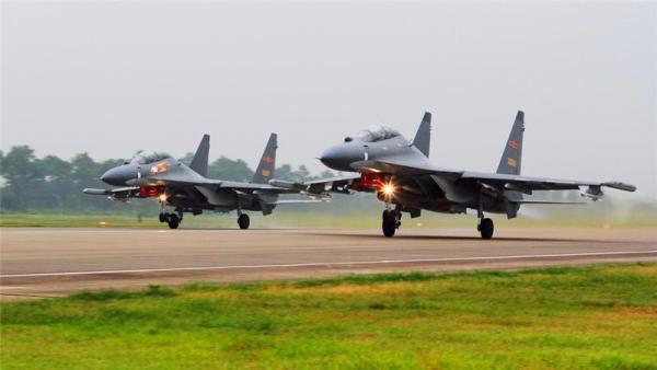 Two Chinese Su-30 fighter jets take off from an unspecified location