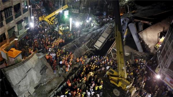 Members of the National Disaster Response Force search for survivors trapped under the rubble
