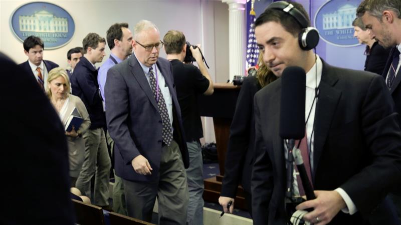 Journalists leave after several major news organisations were excluded from the off-camera 'gaggle'