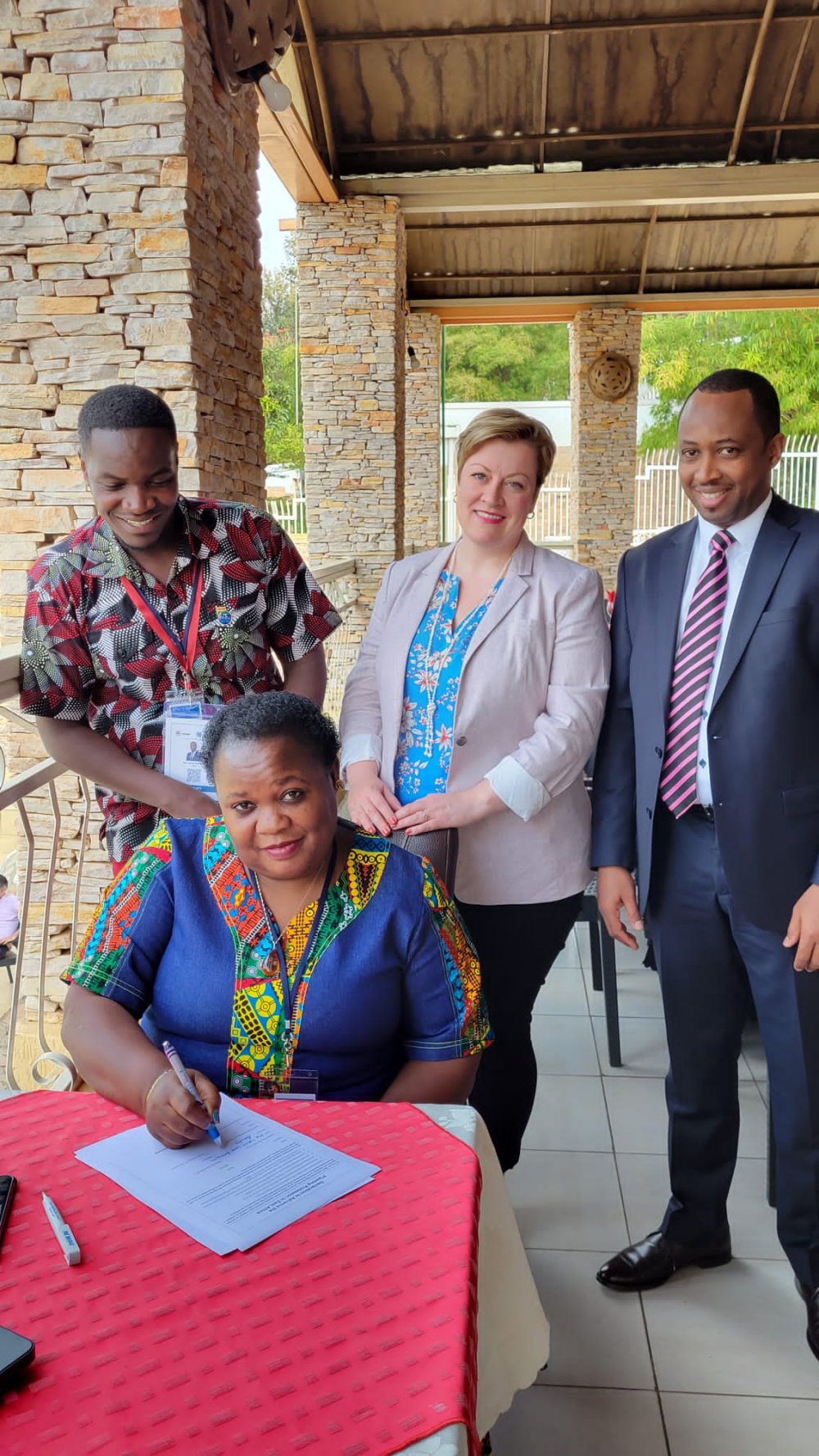 Grace Tubwita from Uganda's association of planners signing a document admitting RUPI. 