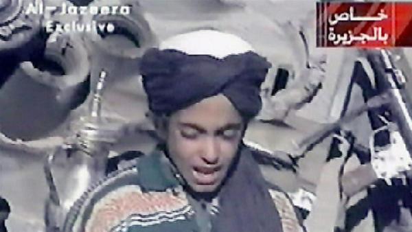 A young Hamza bin Osama bin Laden, seated between two Taliban fighters near Ghazni, Afghanistan in 2001