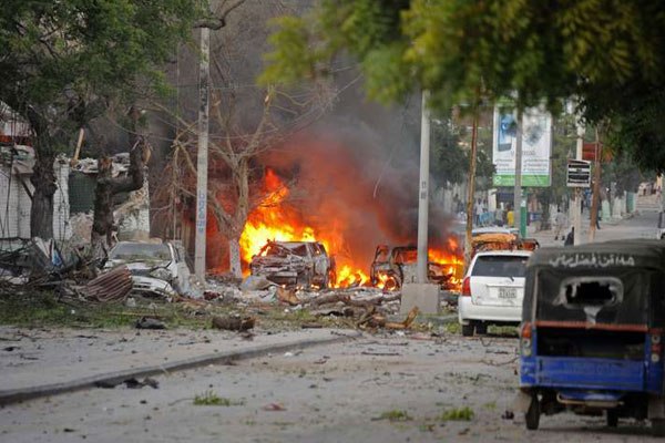 This picture taken on June 1, 2016, shows a car burning after a terror attack at the Ambassador Hotel, after Somalia's Al-Qaeda-linked Shabaab, launched a deadly attack on a top Mogadishu hotel popular with MPs, setting off a car bomb and fighting security forces inside the complex.