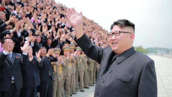 North Korean leader Kim Jong-un waves to officials in this undated photo