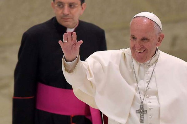 Pope Francis (right) waves to faithfull as he arrives for his audience with participants at the Conference for people with disabilities, promoted by CEI (Italian Episcopal Conference), in Aula Paolo VI at the Vatican, on June 11, 2016.