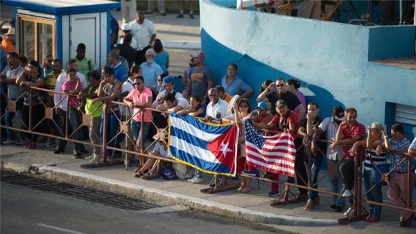 Cubans gather to watch the US flag being raised at the US embassy in Havana in 2014