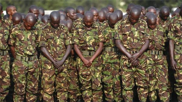 Kenyan soldiers pay respects to fallen comrades killed in the January attack in Somalia