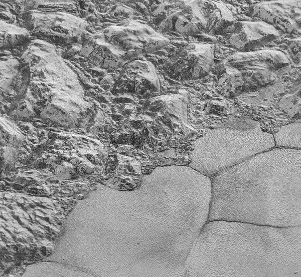 The rugged water-ice al-Idrisi mountains meet the smooth nitrogen-rich ices of Sputnik Planum