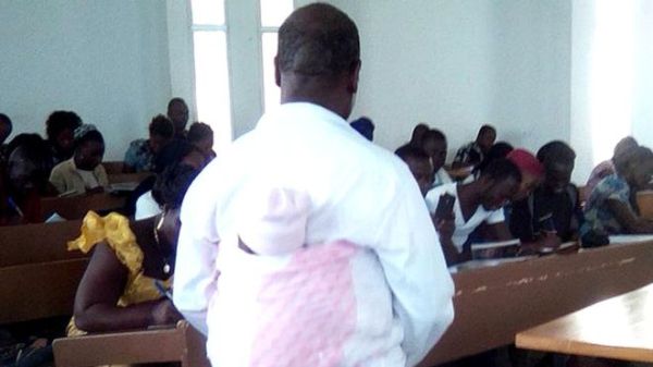 Professor Honore Kahi put the baby on his back so that the mother could concentrate on the class
