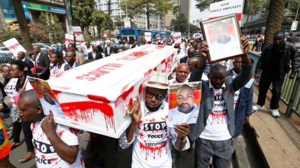 Protestors stained a coffin with red paint to represent fake blood at the rally for human rights lawyer Willie Kimani