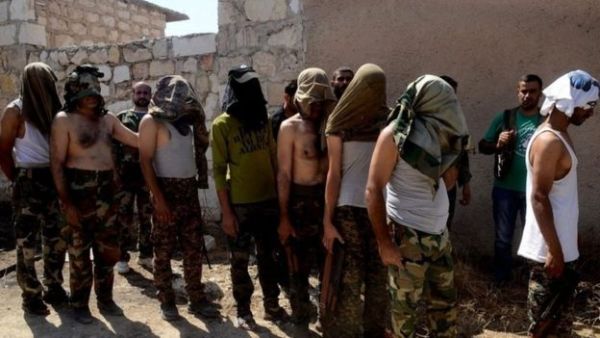 Photographs were released on Tuesday by state media purporting to show opposition gunmen surrendering to the Syrian army in Aleppo