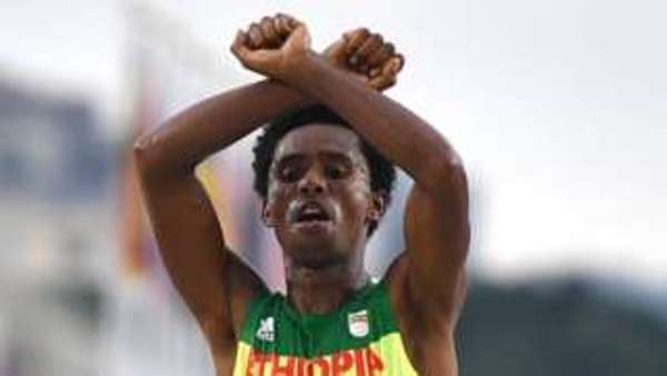 Feyisa Lilesa made the gesture as he crossed the line and again at a press conference