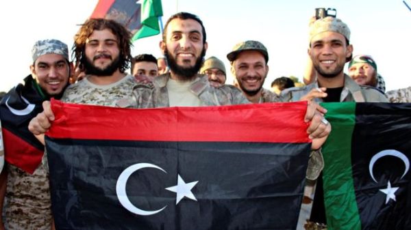 Pro-unity government fighters smile after taking back the last IS-controlled area in Sirte