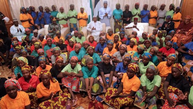 Nigeria's President Muhammadu Buhari applauds as he welcomes a group of Chibok girls, who were held captive for three years by the millitant group Boko Haram, in Abuja, Nigeria, May 7, 2017.He delayed leaving for London in order to meet the girls, his office says