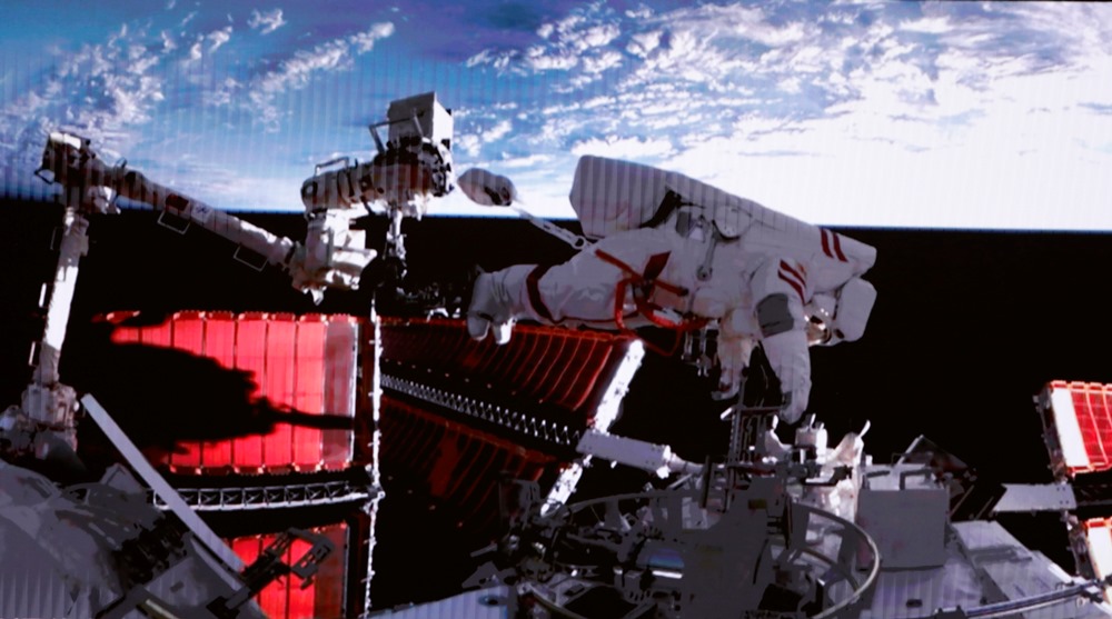 This screen image captured at Beijing Aerospace Control Center on Feb. 9, 2023 shows Shenzhou-15 taikonaut Fei Junlong returning to space station lab module Wentian with equipment.