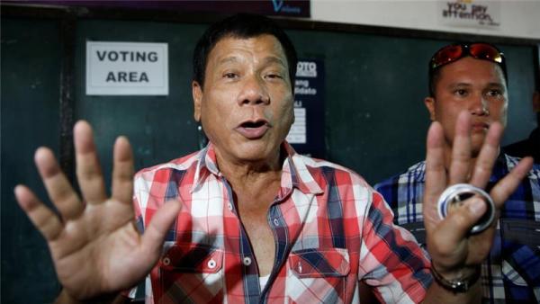 Rodrigo 'Digong' Duterte talks to the media before casting his vote