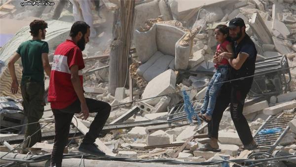 A Syrian man carries a girl from a destroyed building after barrel bombs were dropped in this August 2016