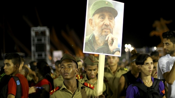 A cadet carries an image of former Cuban leader Fidel Castro