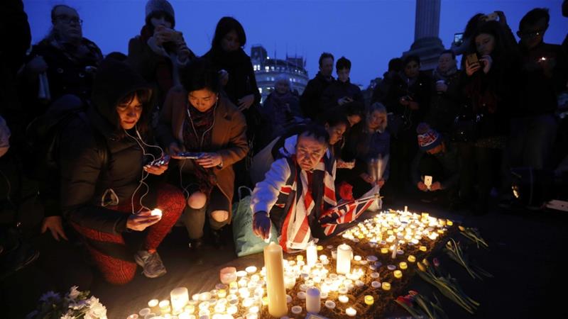 People lit candles in memory of the four victims killed on Westminster Bridge and outside parliament