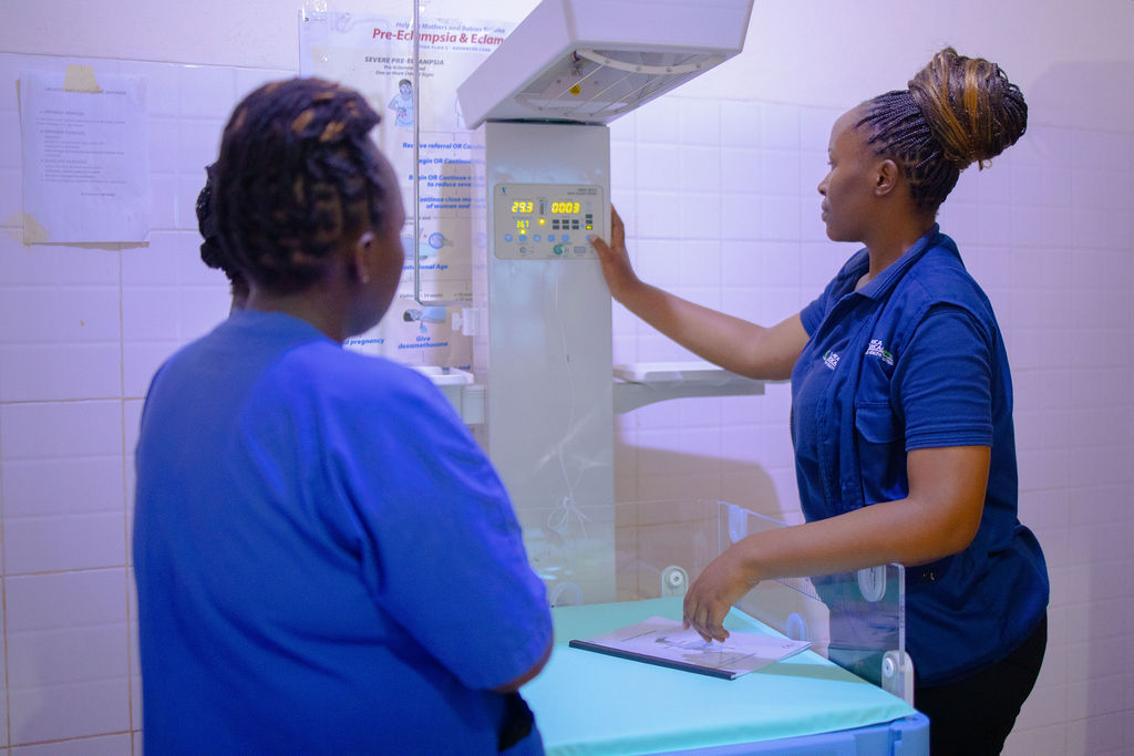 A biomedical engineer from Africa Medical Supplier Plc installs an infant radiant warmer at a rural hospital in Eastern Province to support neonatal care.
