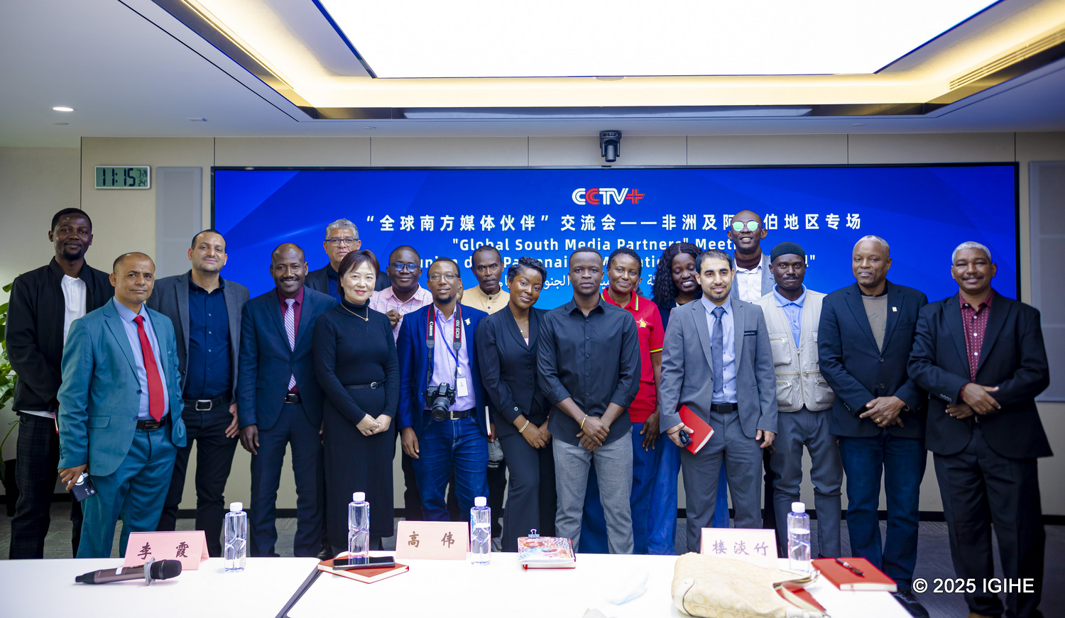 A diverse group of media representatives from around the world poses together.