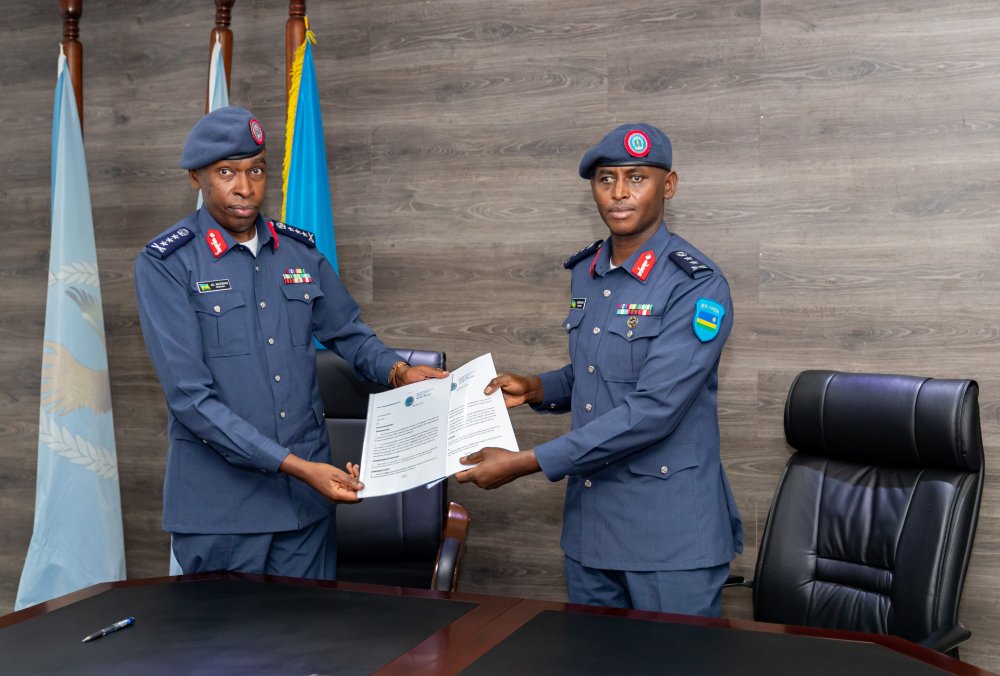Major General Emmanuel Bayingana (right) handing over duties to newly appointed Air Force Chief of Staff, Lt Gen Mupenzi. .