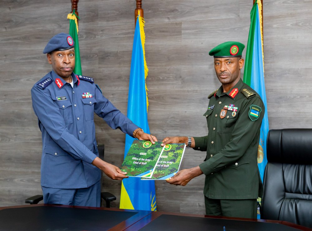 Lt Gen Mupenzi (left) handing over duties to Lt Gen Muganga.