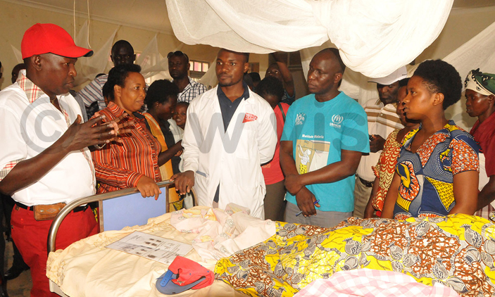 Pascal Barandagiye and his delegation talk to Burundian patients admitted at Nakivale Health Centre III.