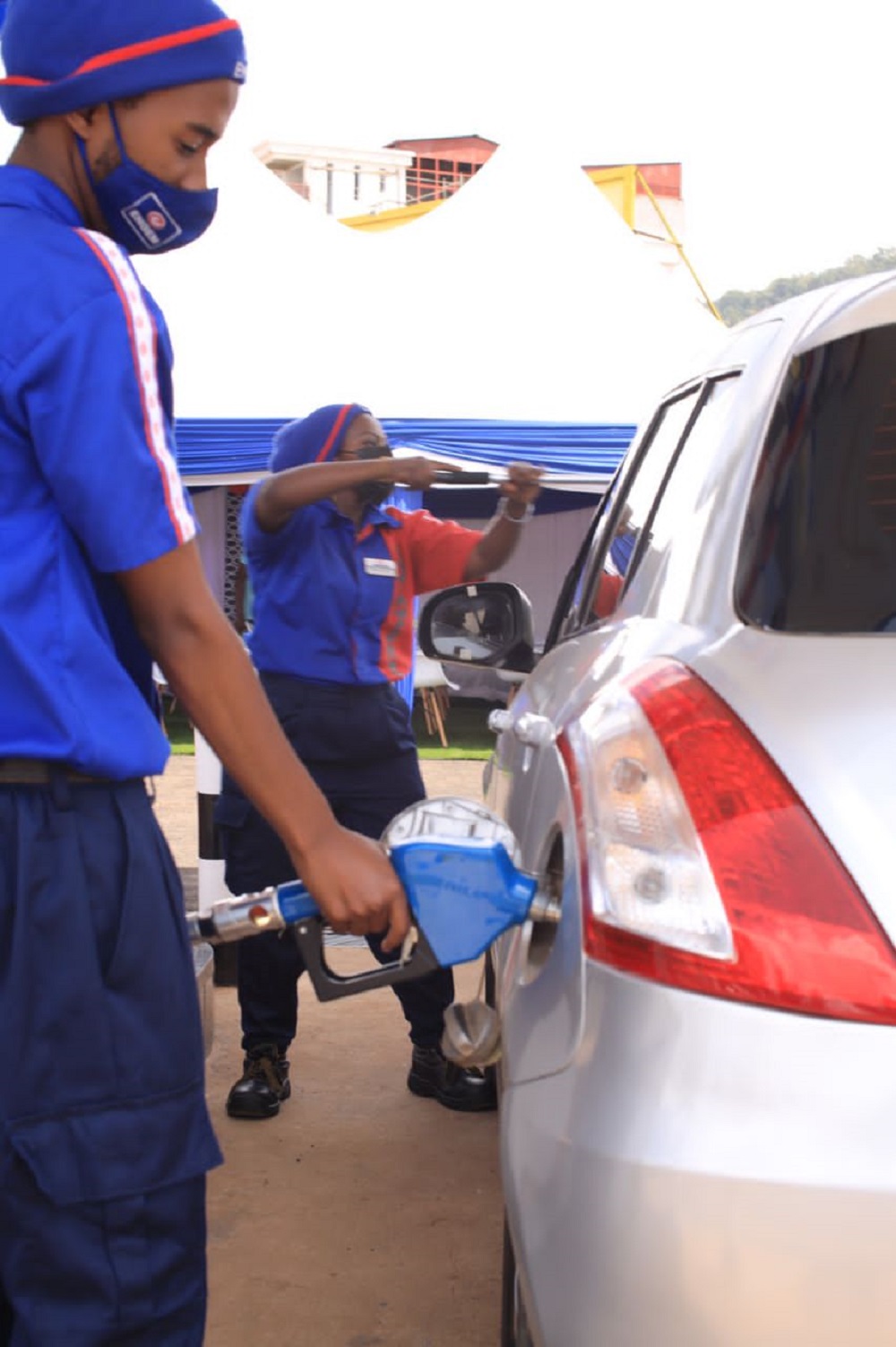 Pump attendants serving customers at the new service station in Nyakabanda.  
