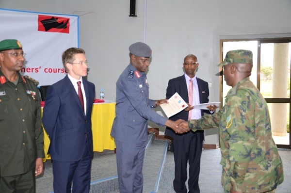 UK High Commissioner, HE William Gelling (second from left) and Brig Gen Karamba handing over certificates to participants