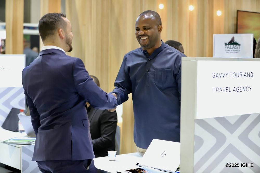 Aimable Rutagarama, Chairperson of the PSF Chamber of Tourism, in conversation with a visitor at ITB 2025.
