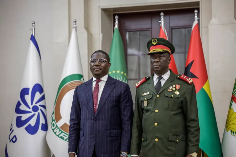 Guinea-Bissau's newly appointed Prime Minister Ilidio Vieira Te, left, stands next to the country's new military ruler, General Horta Inta-A, during a swearing-in ceremony at the Presidential Palace in Bissau, on Friday, November 28, 2025. He later appointed members of the new cabinet on Saturday.