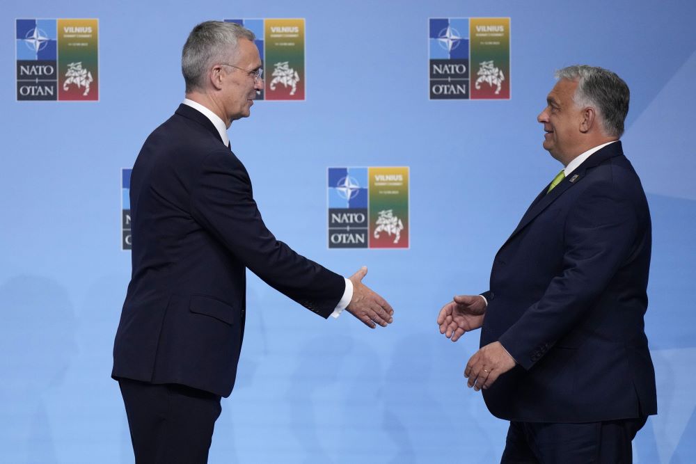 NATO Secretary General Jens Stoltenberg (left) greets Hungary's Prime Minister Viktor Orban during arrivals for a NATO summit in Vilnius, Lithuania, July 11, 2023. (PHOTO / AP)