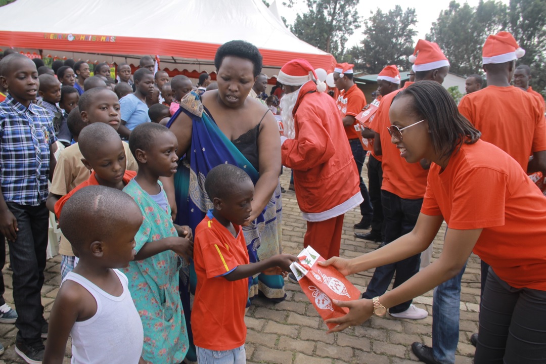 Airtel Rwanda CSR & Corporate Communications manager Denise Umunyana handing out gifts to the children
