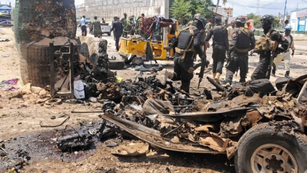 Somali security forces investigate the scene of a suicide attack in Mogadishu on July 31, 2016.
